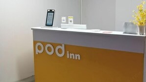 Una recepción con un cartel que dice "pod inn".