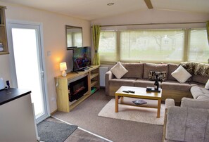 Cabin | Living area | TV, fireplace - The Dorset Coast - A Home Away From Home (Ringwood)