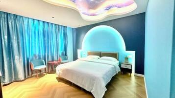 A modern bedroom with a curved ceiling design, a large bed, a nightstand, and a chair.
