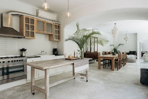 Enjoy a stylish kitchen and dining space with a large island and potted plant.