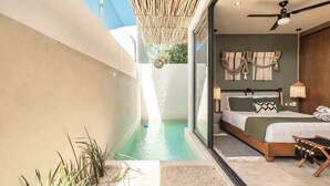 A bedroom with a bed, bedside table, lamp, and a view of a pool. - Gem in the Jungle Private Pool Beach Club Access (Tulum)