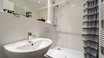 Shower, towels, soap, toilet paper