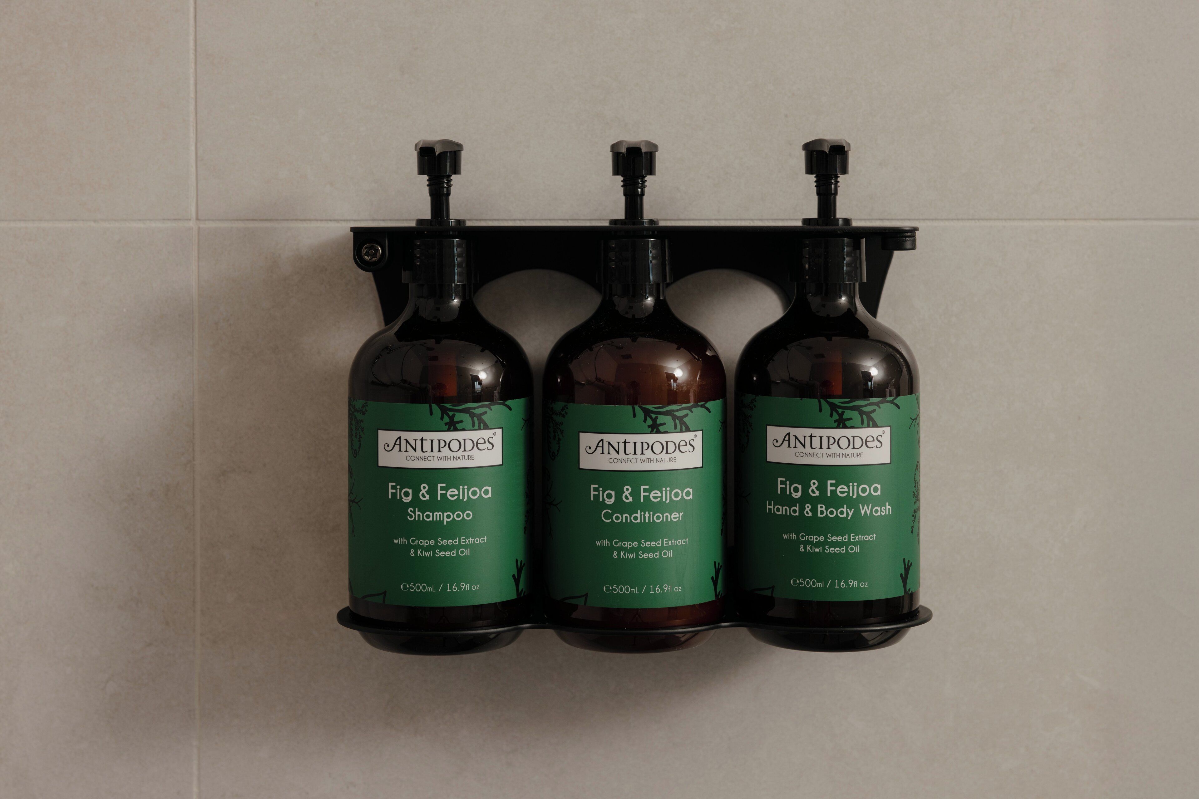 Three bottles of Antipodes products on a wall-mounted rack.