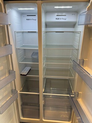 A refrigerator with multiple air flow compartments, transparent shelves, and a freezer drawer. - 1-Bedroom Flat in Islington! (Greater London)