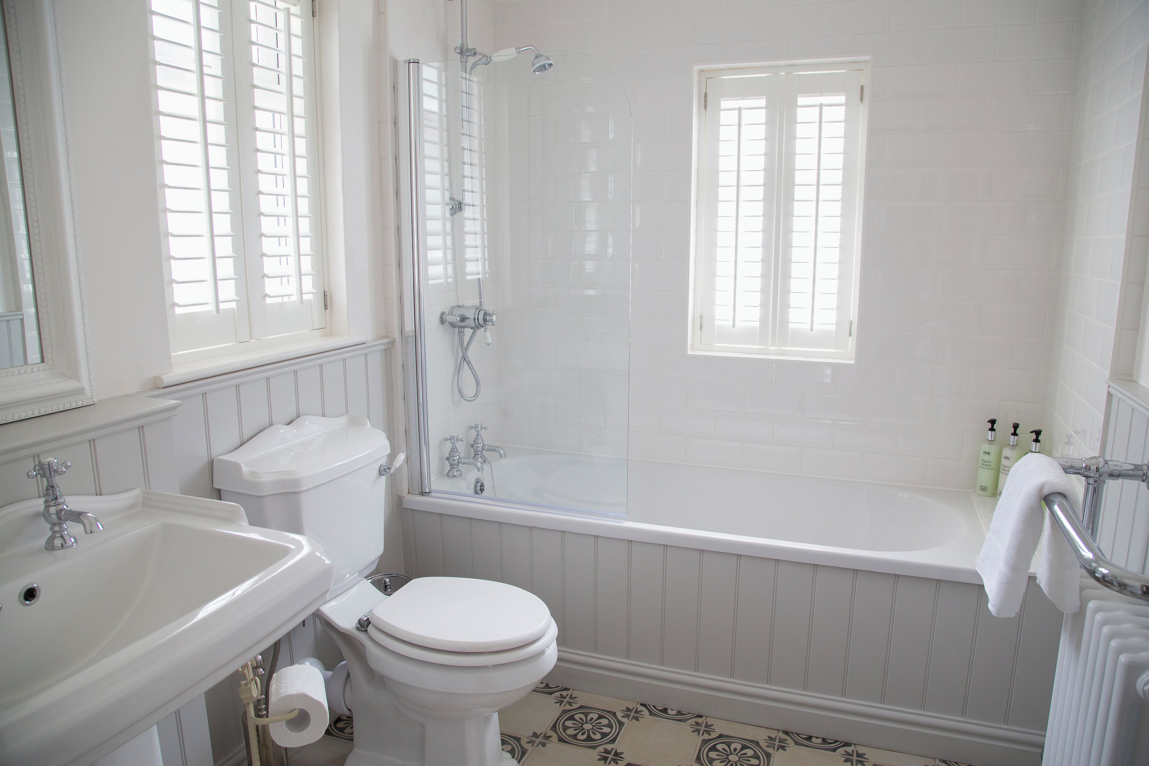 A bathroom with a sink, toilet, bathtub, and shower.