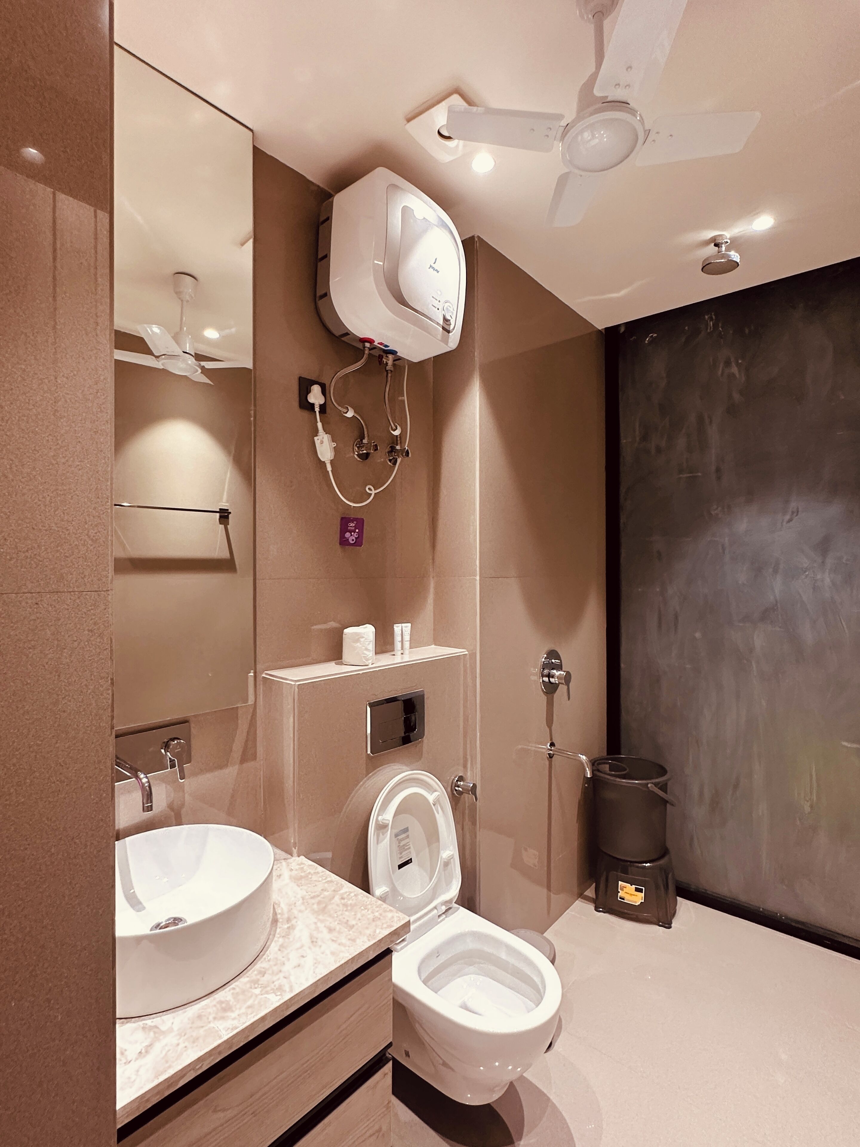 A modern bathroom with a toilet, sink, and shower.
