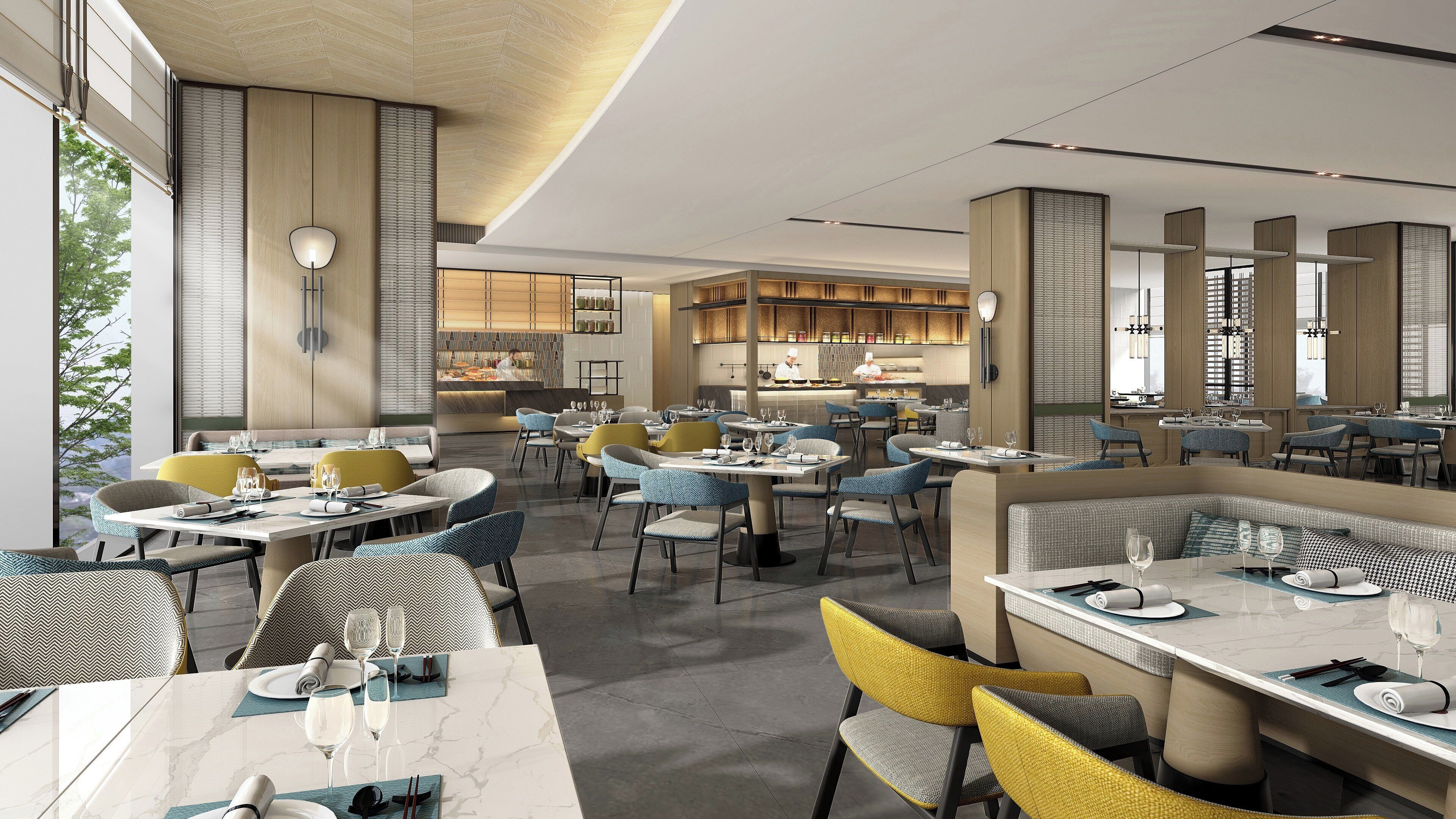 A modern restaurant with marble tables, upholstered chairs, and a view of the kitchen.