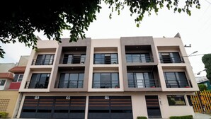 Un edificio de varios pisos con tres puertas de garaje identificadas como G1, G2 y G3.