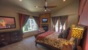 A bedroom with a bed, a TV, a ceiling fan, and a dresser. - Enormous luxury cabin rental in unbeatable South Tahoe location (South Lake Tahoe)
