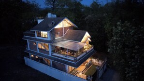 A multi-story house with a balcony and a covered outdoor area. - Rahta Villa - An Elegant 3BR Villa With BBQ Terrace (Dehradun)