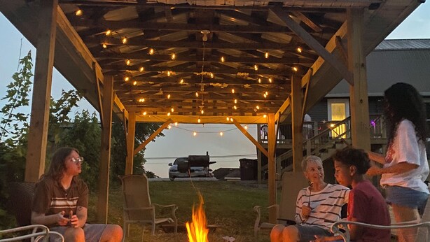 A gazebo with a fire pit in the center, surrounded by outdoor seating. - 
Historic beauty with partial lake views, walking distance to Burnside Marina!  (Burnside)