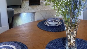 A living room with a sectional sofa, a coffee table, and a dining table with placemats. - 
Historic beauty with partial lake views, walking distance to Burnside Marina!  (Burnside)