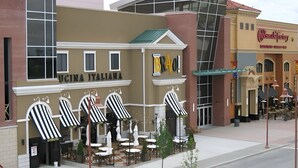 A building with a sign reading "UCINA ITALIANA" and outdoor seating with striped umbrellas. - Historic Mansion Built in 1896, Pan Am. Expo Era (Buffalo)