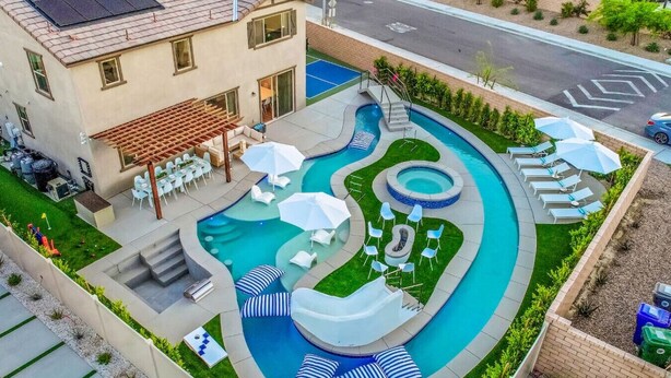 A residential property with a swimming pool, outdoor seating, and a pergola. - Lazy River Pool+Spa+Pickleball+Game Room+BBQ+Golf (Coachella)
