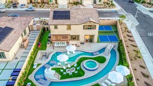 A residential property with a swimming pool, outdoor seating, and a tennis court. - Lazy River Pool+Spa+Pickleball+Game Room+BBQ+Golf (Coachella)