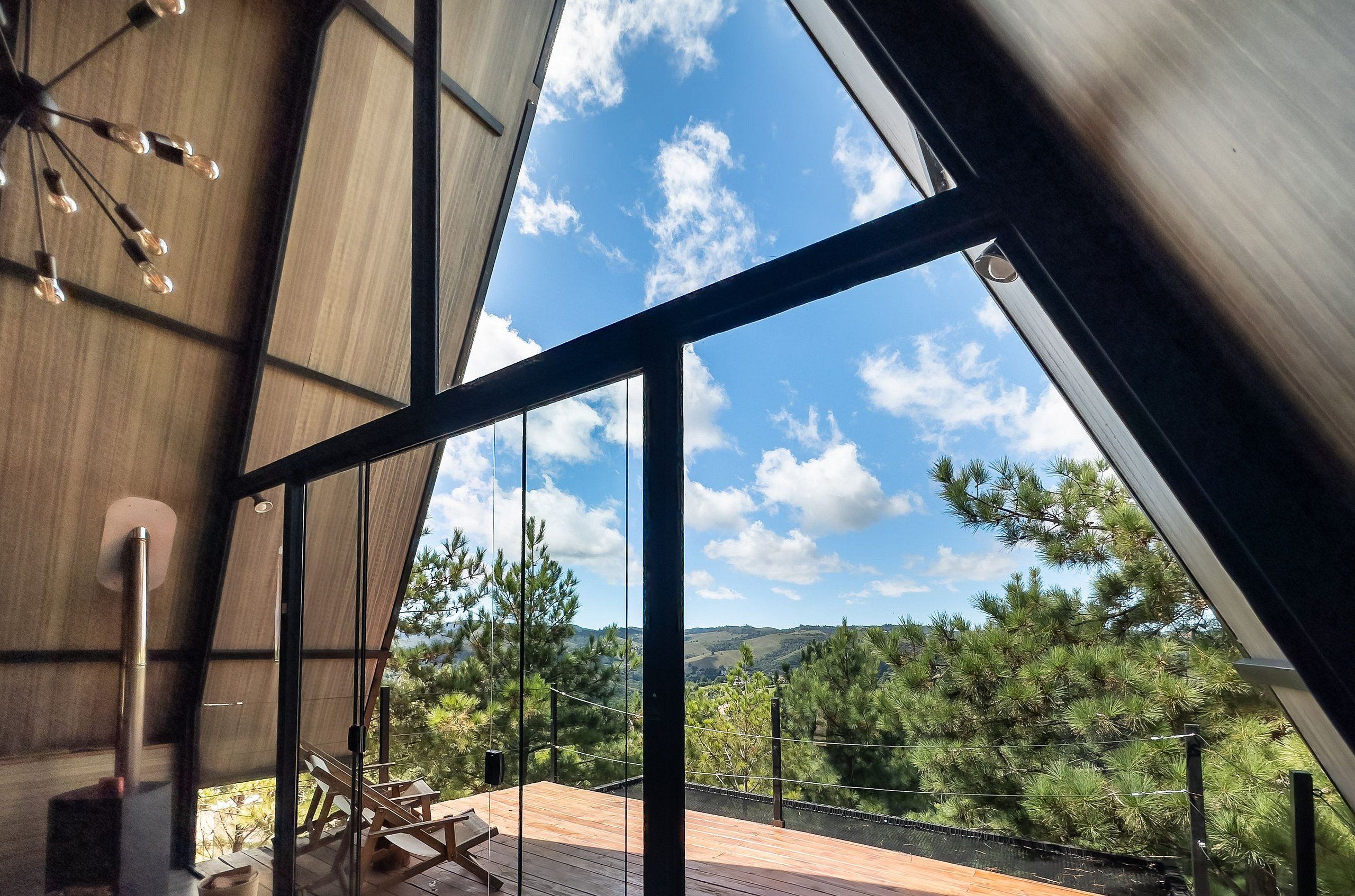 A modern interior with a large glass window offering a view of a mountainous landscape.