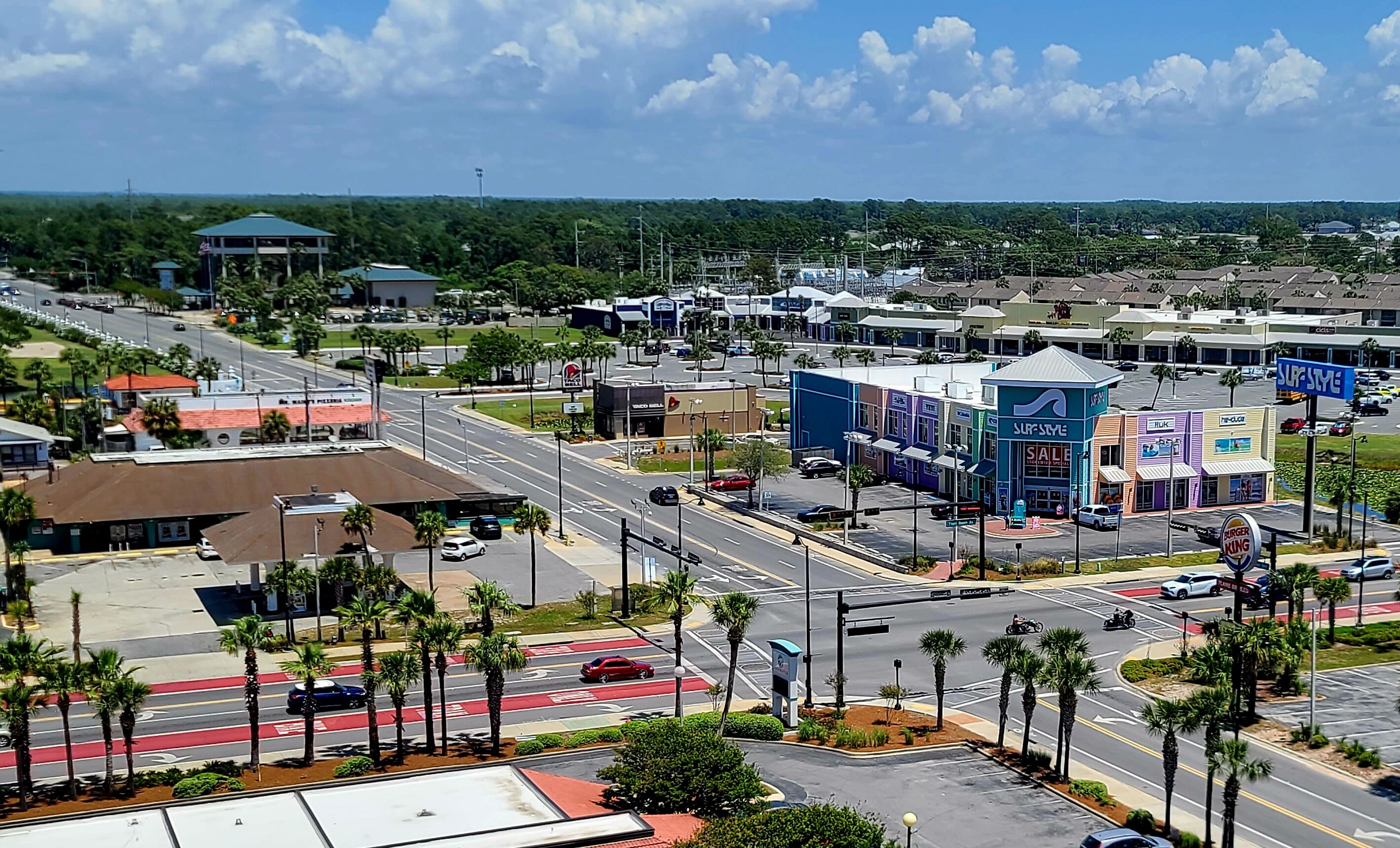 A commercial area with multiple stores, including a Burger King and a Surf Style building.