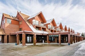 A row of red-brick buildings with a flat roof and a storefront named "The Shirt Off My Back." - BEST LOCATION: Ski-in/Ski-out Studio, Park City Base - 162 Lodge at Mtn Village (Park City)