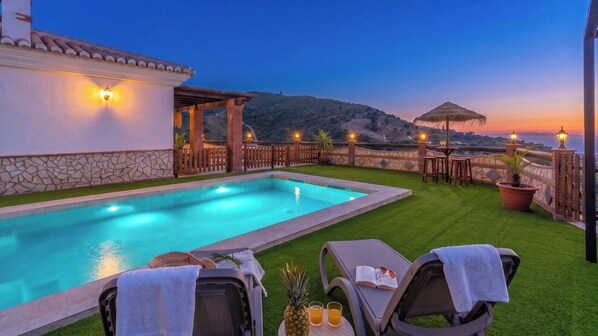 A swimming pool with lounge chairs and a view of the hills. - Casa La Solana Torrox by Ruralidays (Málaga)