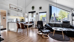A modern living space with a kitchen, dining area, and seating area.