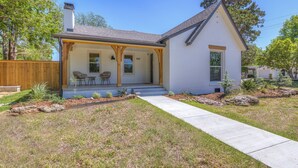 A single-story house with a covered porch, a front door, and a small front yard with landscaping. - Luxury 3BD 2bath Near EXPO & TU (Tulsa)