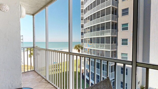 A balcony with a view of the ocean and a multi-story building. - Crescent Arms Vacation Rentals 403 N Siesta Key Florida (Siesta Key)