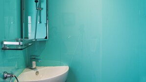 A bathroom with a white sink, a mirror, and a shower. - 2 bedroom accommodation in St Clether, near Launceston (St Clether, near Launceston)
