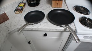 A kitchen with two black frying pans on a white stove. - Duplex in Lexington, VA, Loranwoods (Rockbridge County)