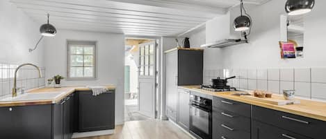 Fridge, stovetop, dishwasher, coffee/tea maker