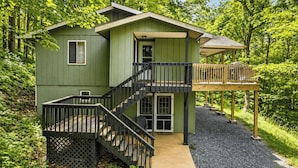 A green cabin with a wooden deck, a staircase, and a covered porch. - Ash Vale by Avantstay Expansive Deck + Ping Pong + Covered Porch Blue Ridge Mountain Escape (Mars Hill)