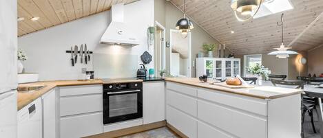 Fridge, stovetop, dishwasher, coffee/tea maker