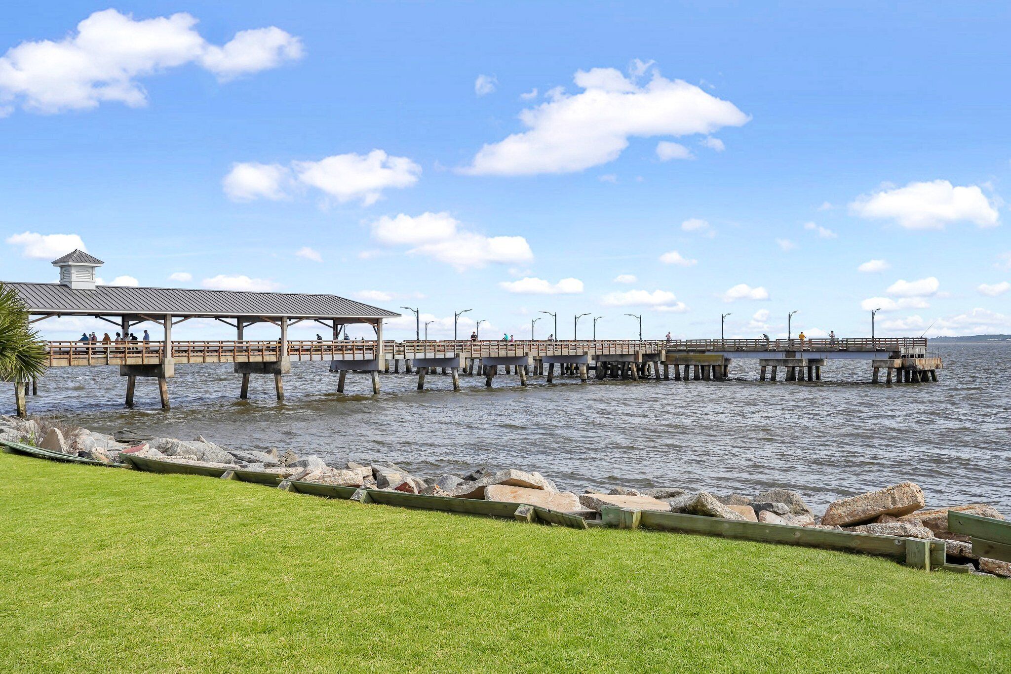 A pier extending into a body of water with a covered structure at the end.