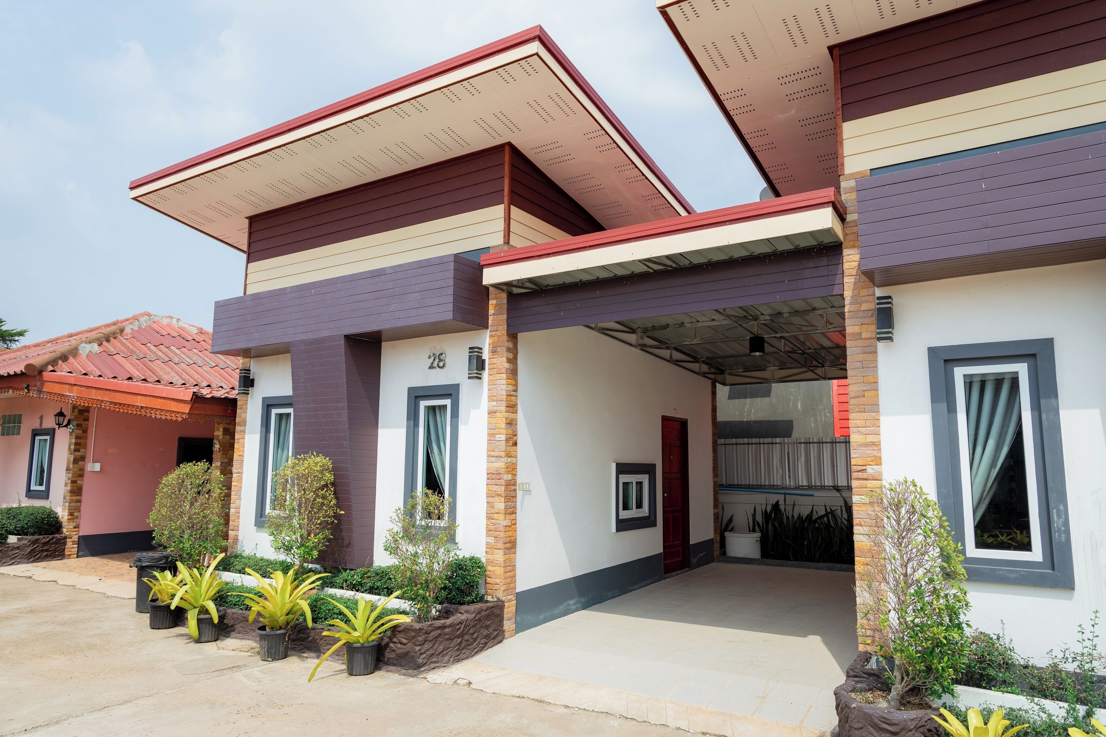 A modern two-story house with a covered porch and a number '28' sign.