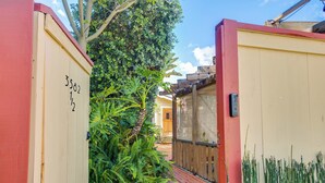A narrow pathway leading to a building with a wooden door marked "3582 1/2".