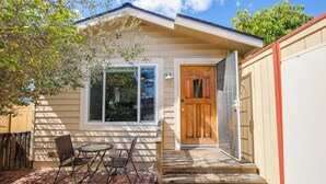 A house with a front porch, a wooden door, and a window.