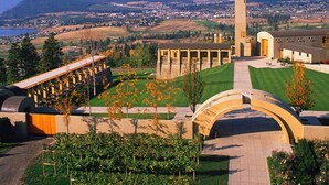 A large building with a central tower, surrounded by a well-maintained lawn and a curved walkway.
