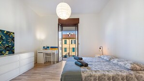 Une chambre à coucher avec un lit, un bureau et une chaise.