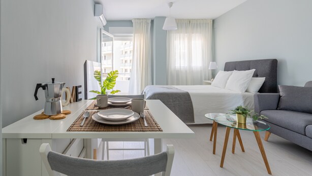 A modern hotel room with a dining area, a bed, and a sofa. - Studio Apartment 'Torremolinos Dream Sea Views' with Sea View, Wi-Fi & Air Conditioning. (Torremolinos)