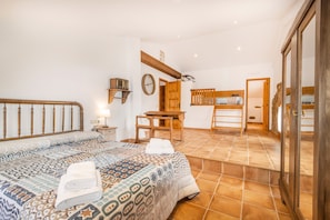 A bedroom with a bed, bedside tables, a wooden chair, a desk, and a wardrobe. - Holiday Home 'Casa Ponet' with Mountain View, Private Pool and Wi-Fi (Solsona)