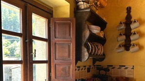 Une cuisine dotée d’une grande fenêtre, de meubles en bois, d’un évier et d’un pare-feu en carrelage.
