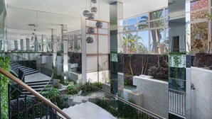 A modern interior with a staircase, glass walls, and indoor plants. - Vacation Apartment 'Casa Ana' with Sea and Teide View, Shared Pool and Wi-Fi (SANTA URSULA)