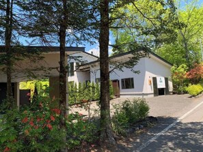 Set amidst lush greenery, this two-story building offers a serene retreat with a clean, modern design.