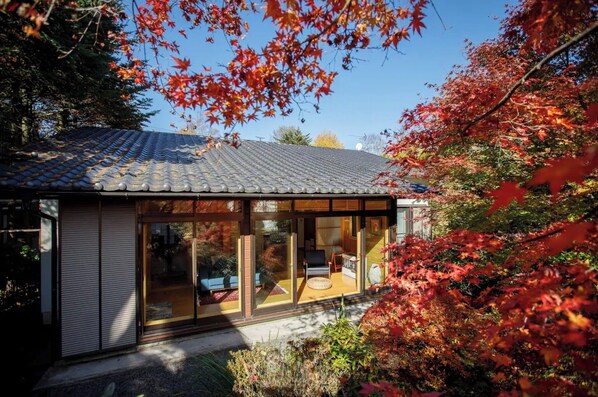 Set amidst lush greenery, this residence offers a unique blend of traditional and contemporary design.