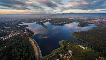 An aerial view of a lake surrounded by forested areas and small settlements.