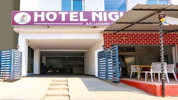 A hotel entrance with a sign reading "HOTEL NIGHT A/C LUXURY". - Fabexpress Night Eye (Hyderabad)