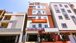 A multi-story hotel with a sign for "Tabexpress" and "Hotel Night Inn A.C. Luxury Rooms". - Fabexpress Night Eye (Hyderabad)