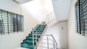 A staircase with metal railings and marble steps in a building. - Fabexpress Olive Inn (Ujjain)