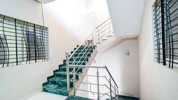 A staircase with metal railings and marble steps in a building.