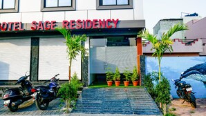 A building with a sign reading "HOTEL SAGE RESIDENCY." - Fabhotel Sage Residency (Indore)