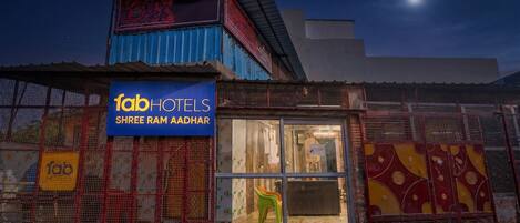 A hotel with a sign reading 'fabHOTELS SHREE RAM AADHAR' and a visible reception area.